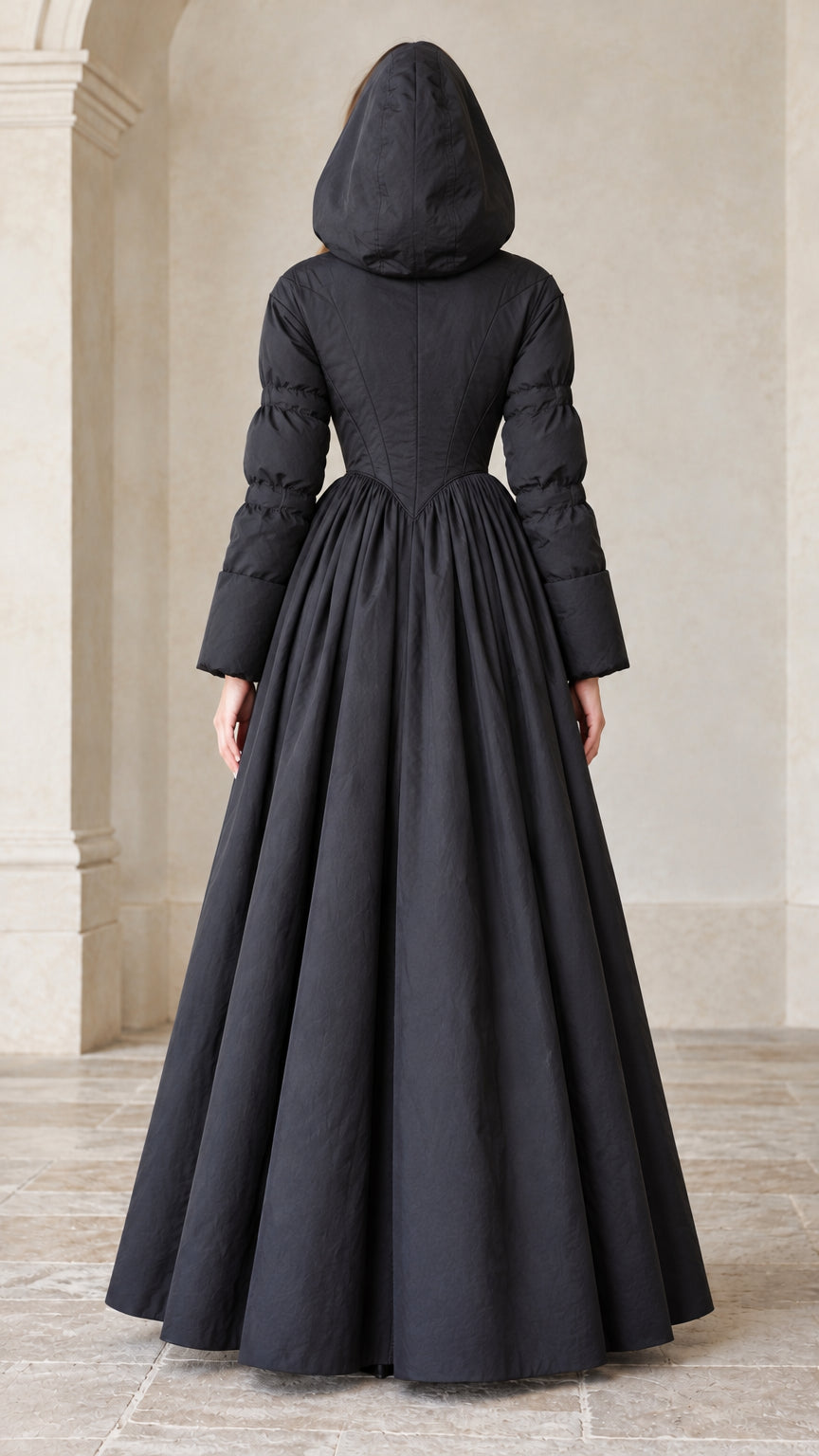 Back full-length view of black hooded maxi gown coat with hood raised