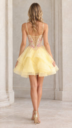 Back view of model showing the lace-up corset back of the yellow mini dress