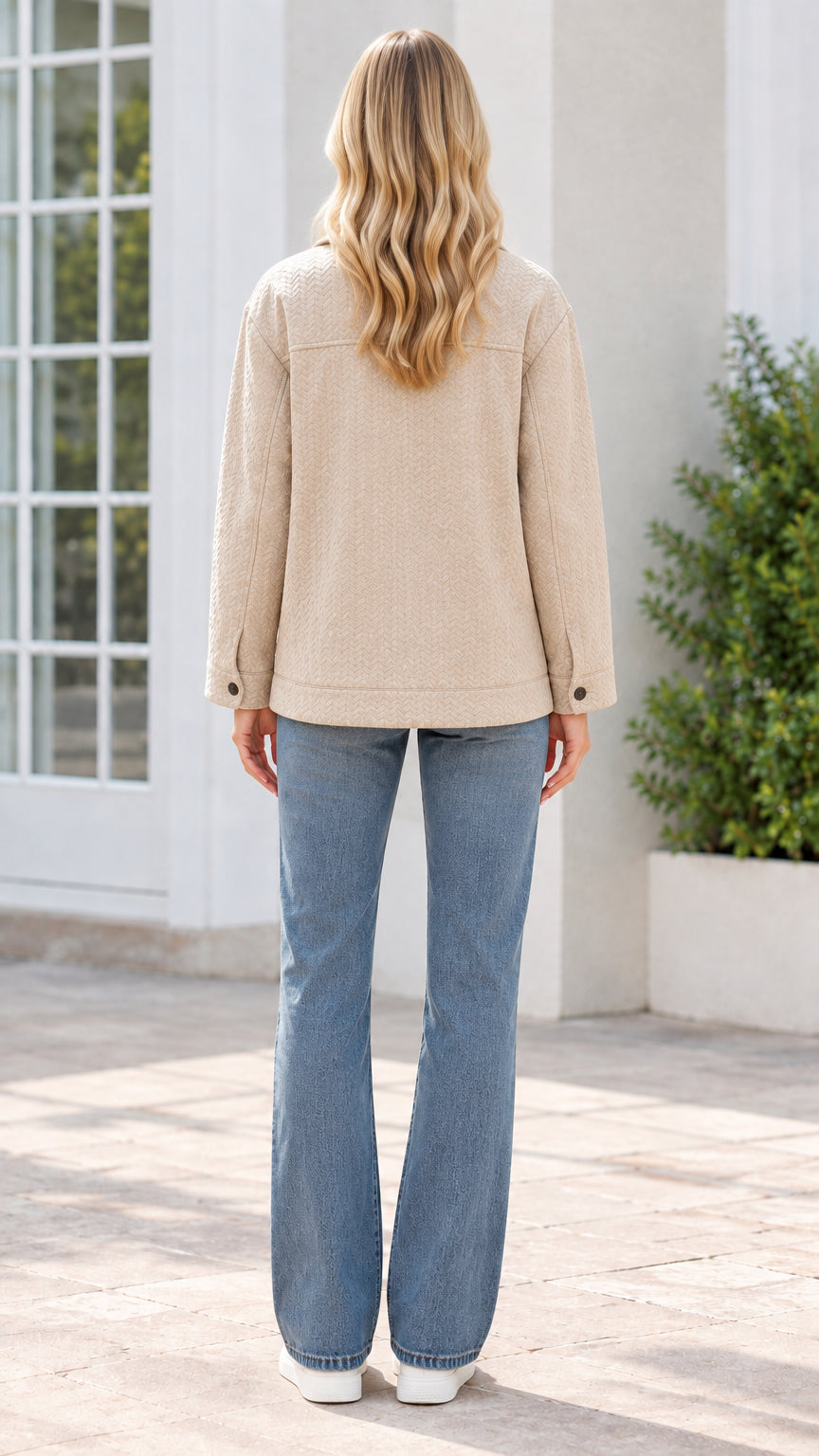 Back view of model wearing beige textured shirt jacket and jeans