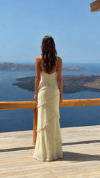 Back view of ivory tiered cami maxi dress showing low back design