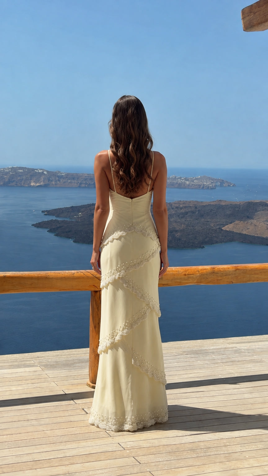Back view of ivory tiered cami maxi dress showing low back design
