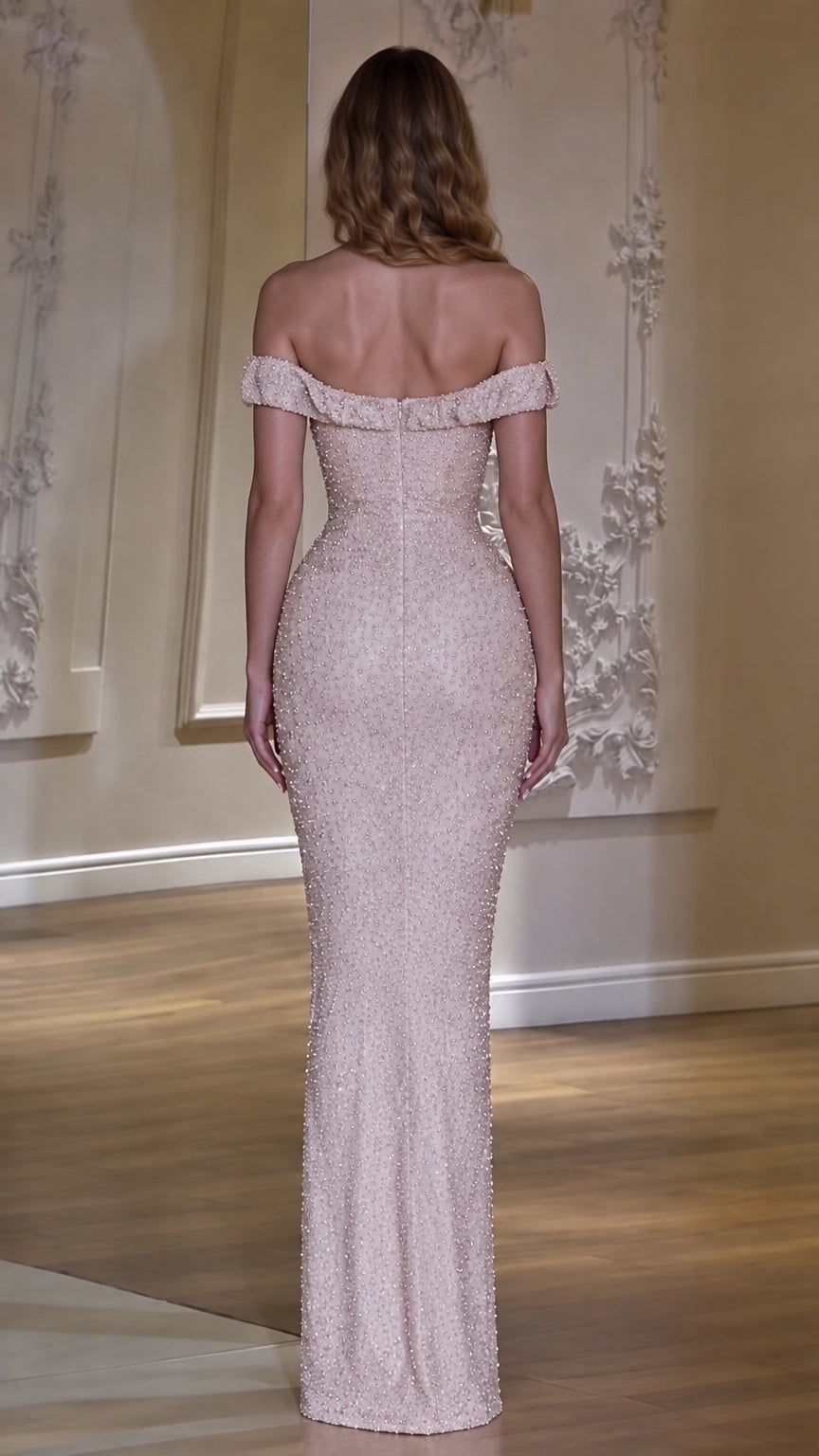 Back view of model wearing a blush pink off-the-shoulder floor-length evening dress