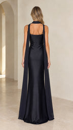 Back view of black satin evening gown highlighting the trailing capelet streamers