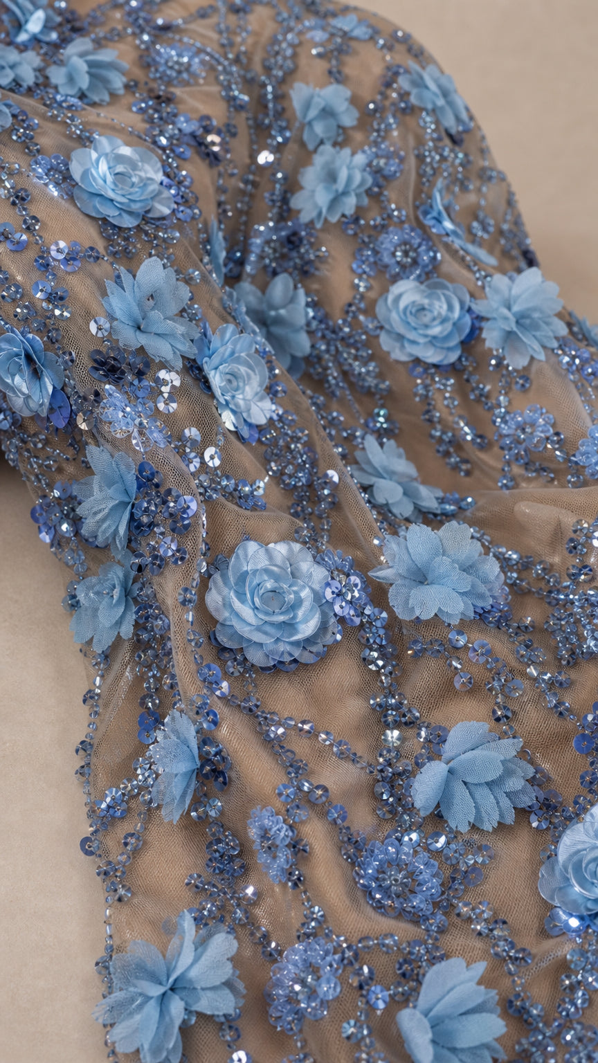 Close-up detail of blue 3D flower appliques and shimmering sequin embroidery on mesh