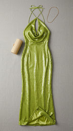 Flat lay of lime green halter cowl neck sequin maxi dress with gold clutch and necklace