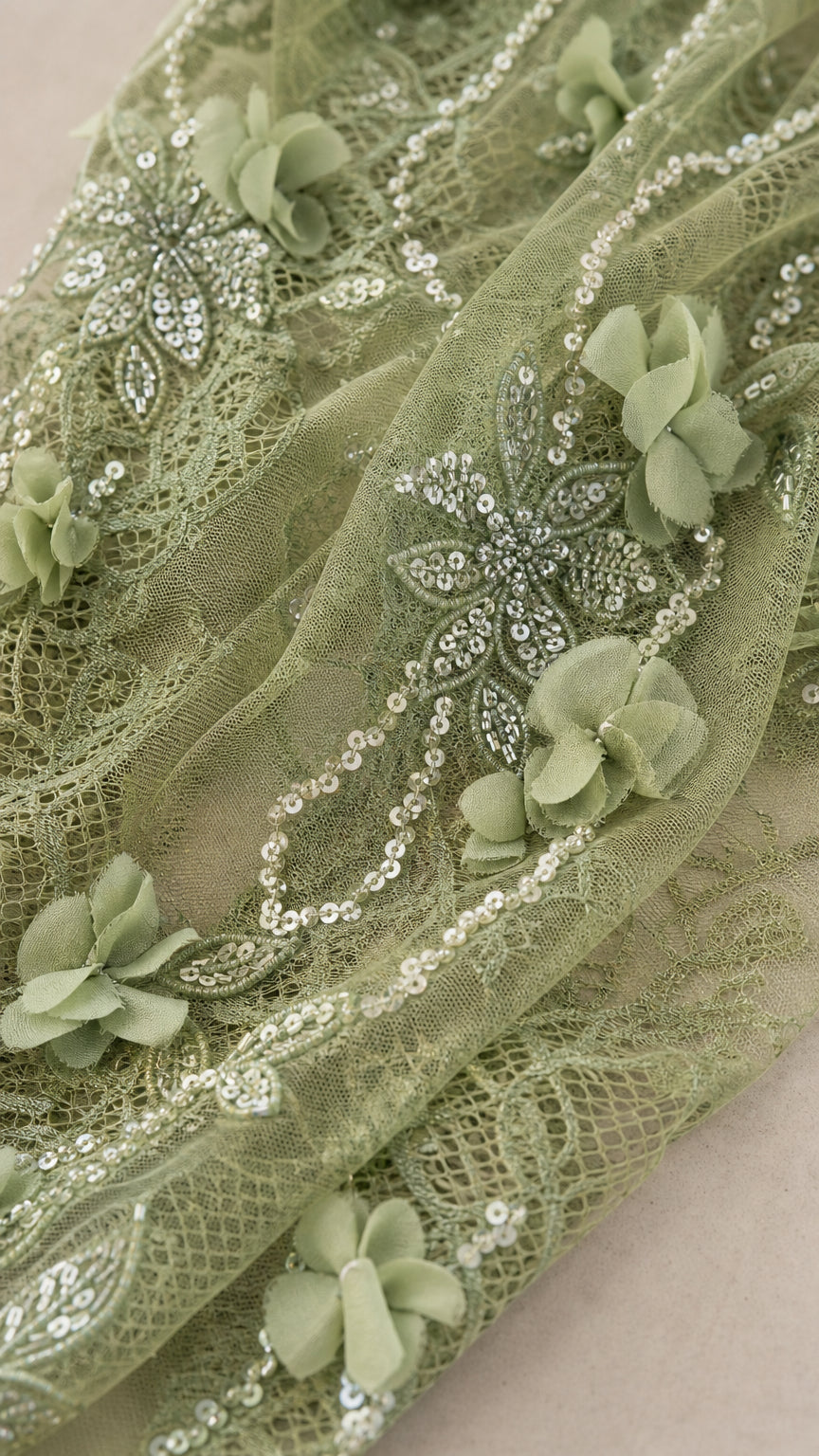 Close up view of 3D floral petals, sequin embroidery, and lace mesh fabric