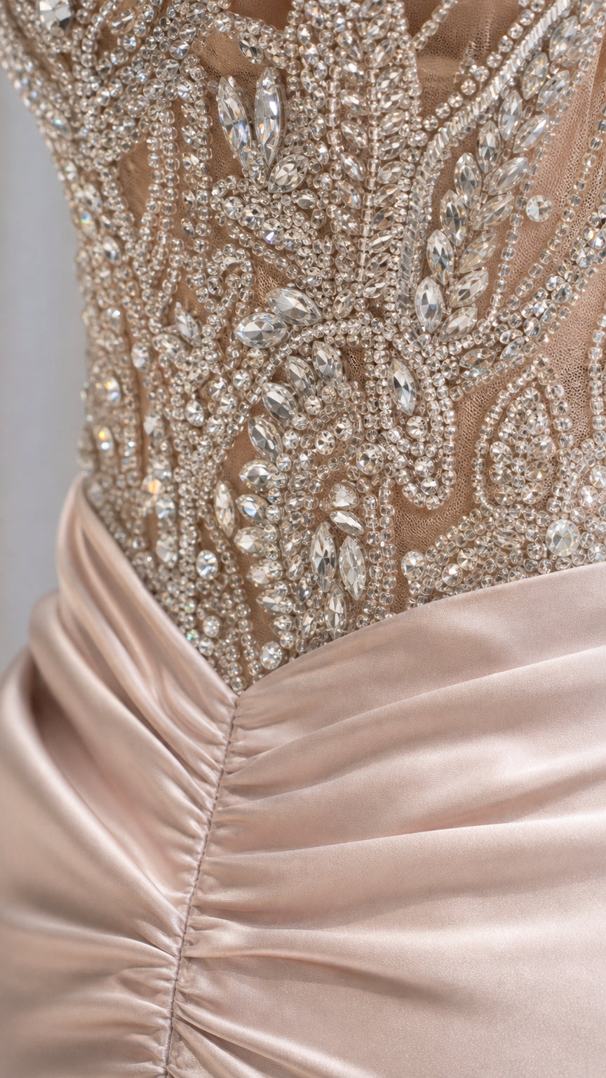 Close-up detail of intricate crystal beadwork and ruched satin waist