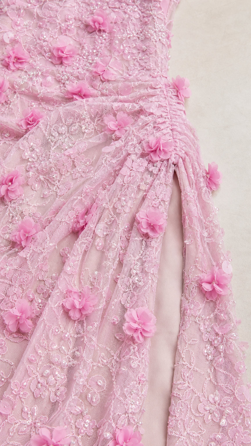 Close-up detail of 3D floral embellishments and embroidered lace fabric