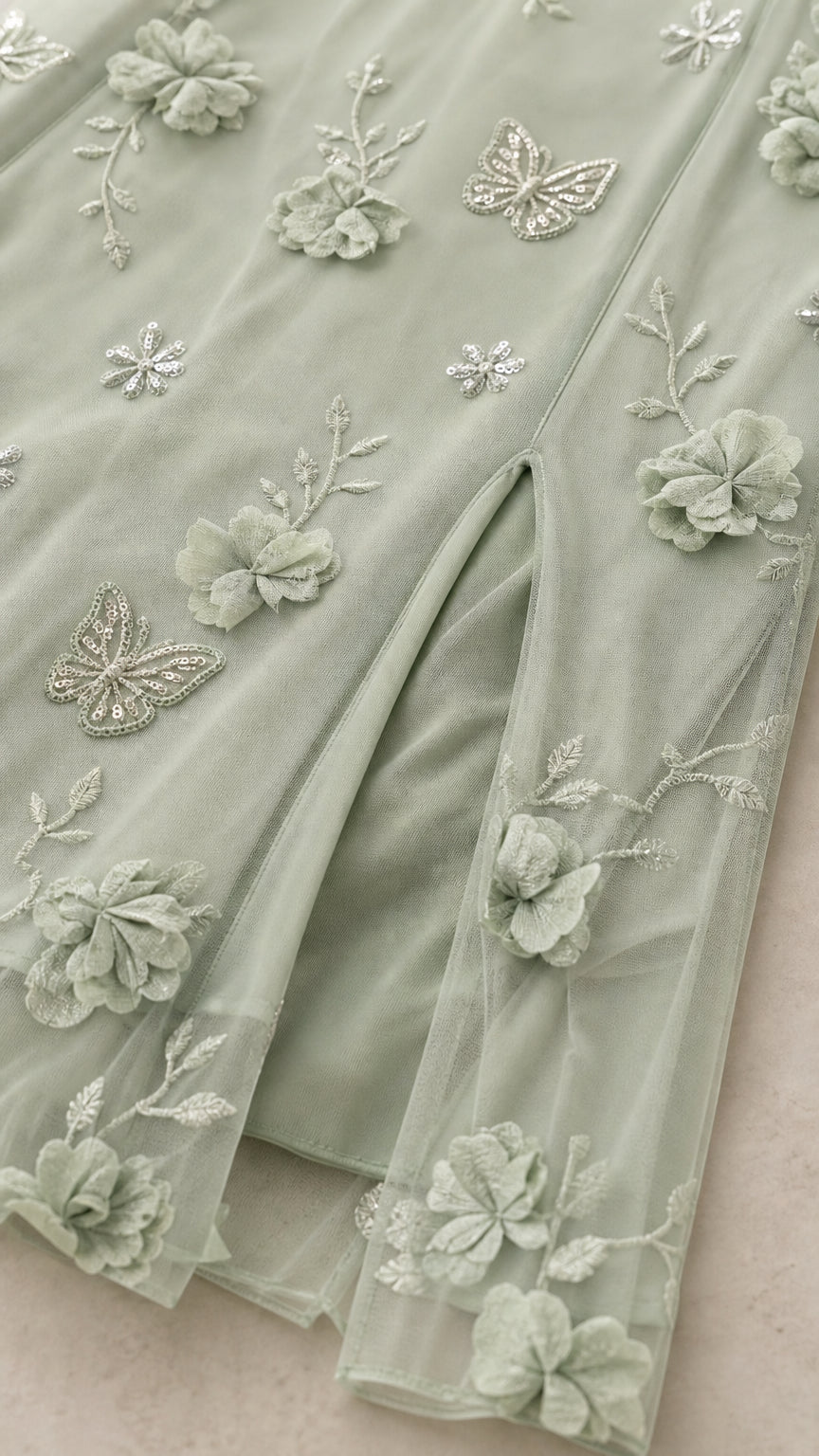Close-up detail of Sage Green 3D floral embroidery, butterfly appliqué, and side slit