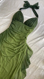 Flat lay close-up of olive green shimmering ruched halter dress