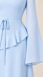 Close-up detail of light blue waist ruffle tier and flared bell sleeve