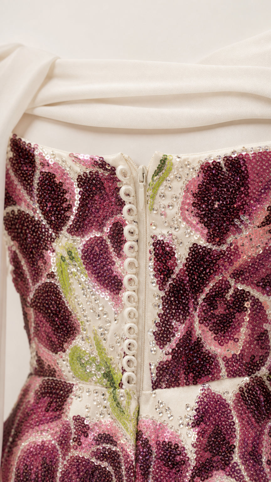 Close-up detail of purple floral sequin embroidery and back button closure