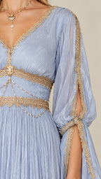 Close-up detail of ornate gold embroidery and V-neckline on Light Blue gown