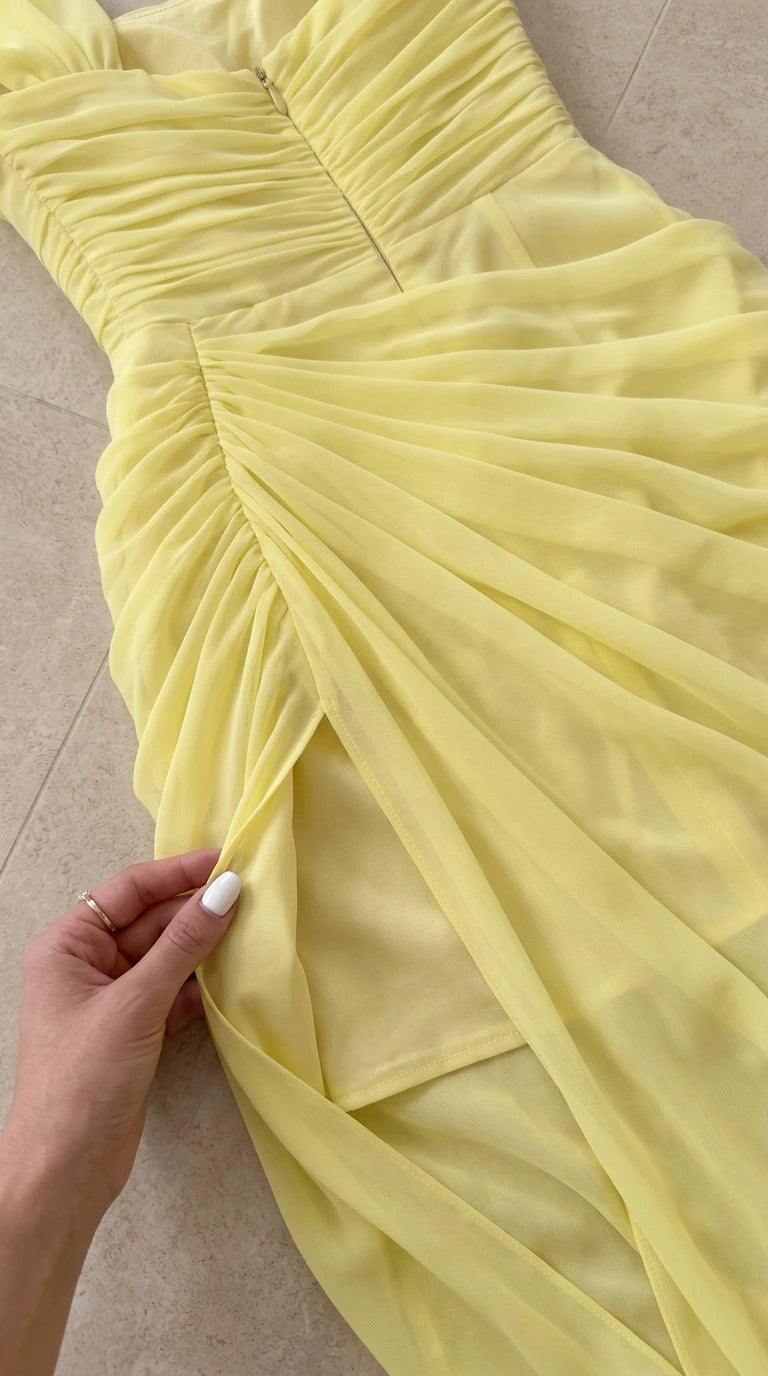Close-up detail of the yellow ruched fabric construction and concealed back zipper