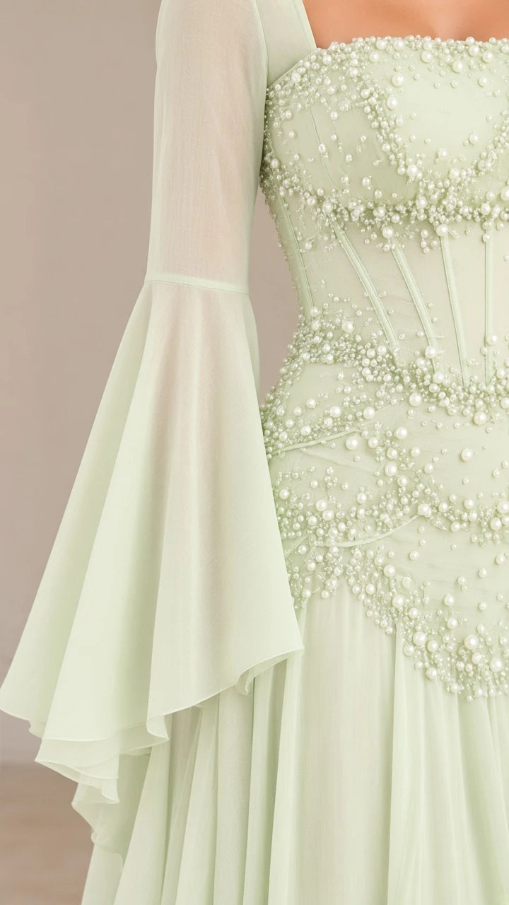 Close up of sage green bodice showing intricate pearl-like bead embellishment and boning