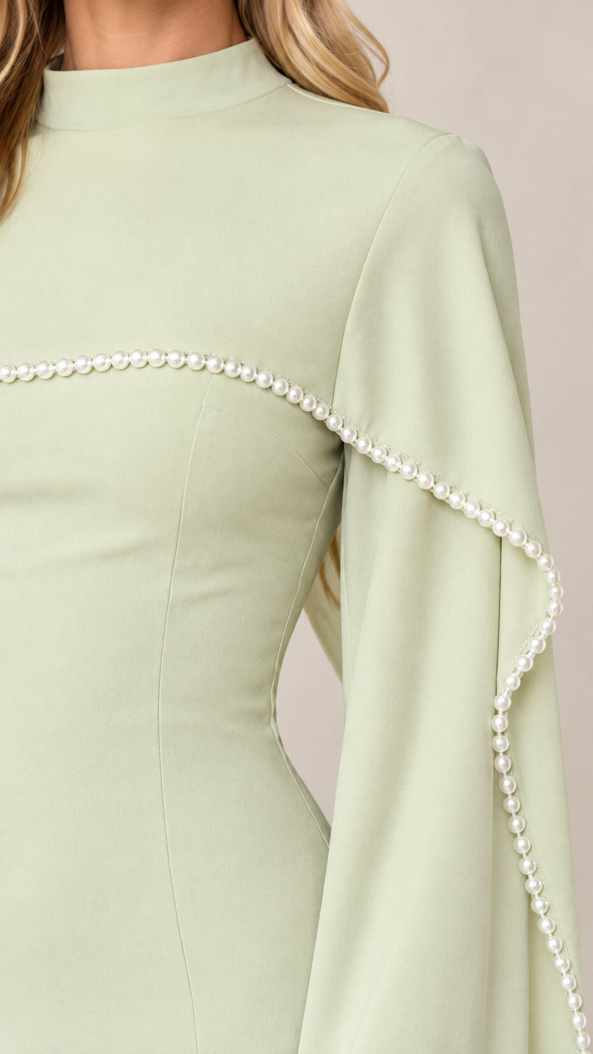 Close-up detail of high neckline and faux pearl trim on sage green cape evening gown