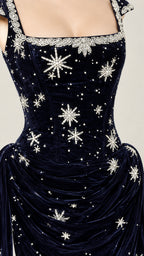 Close-up detail of embellished square neckline and draped waist on navy blue velvet gala gown