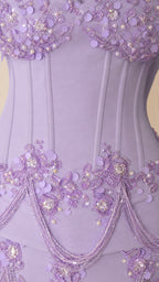 Close-up of boned corset bodice with 3D floral sequin appliqués and pearl beadwork