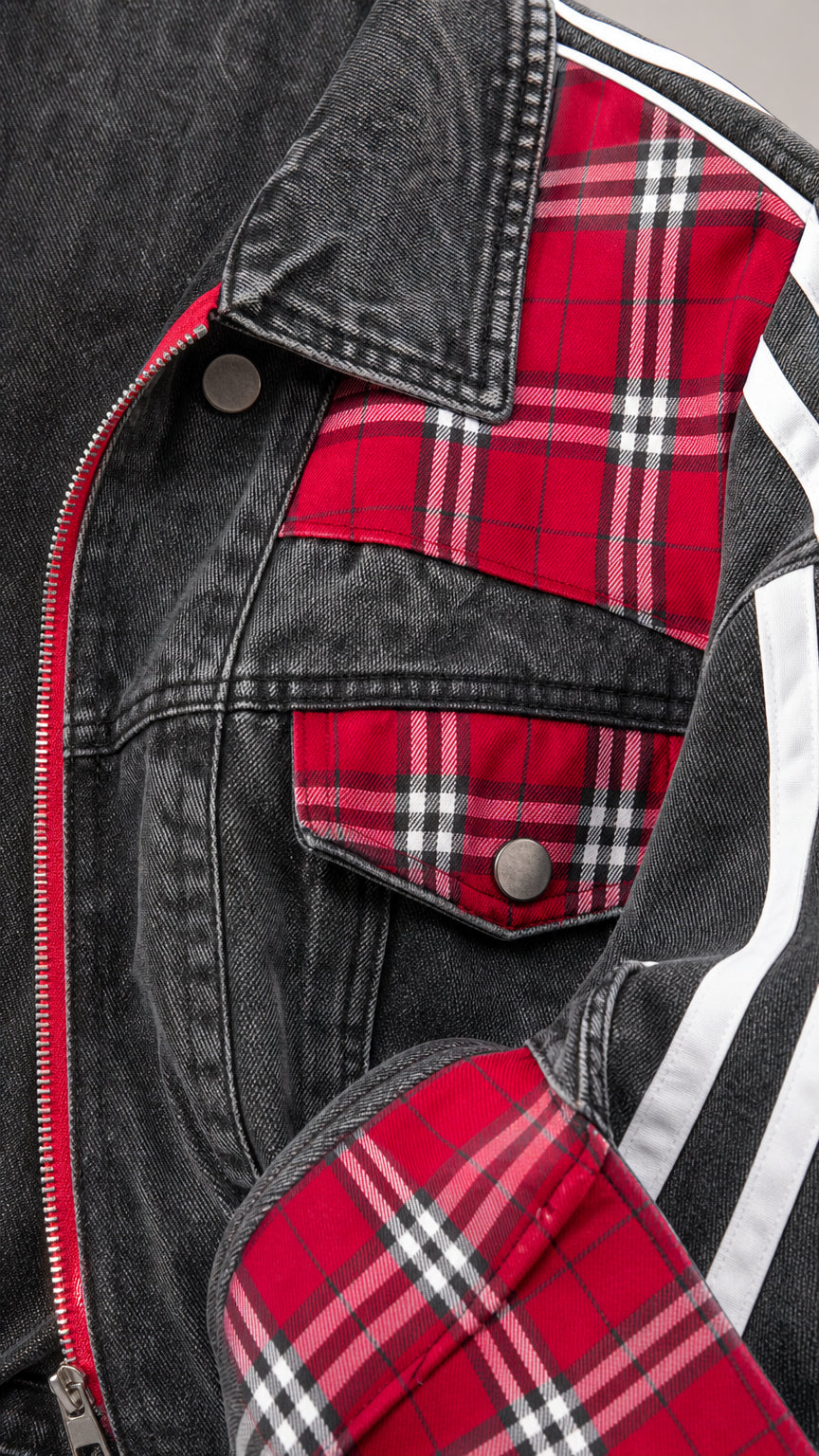 Close-up detail of chest flap pocket and cuff featuring red plaid fabric and silver-tone hardware