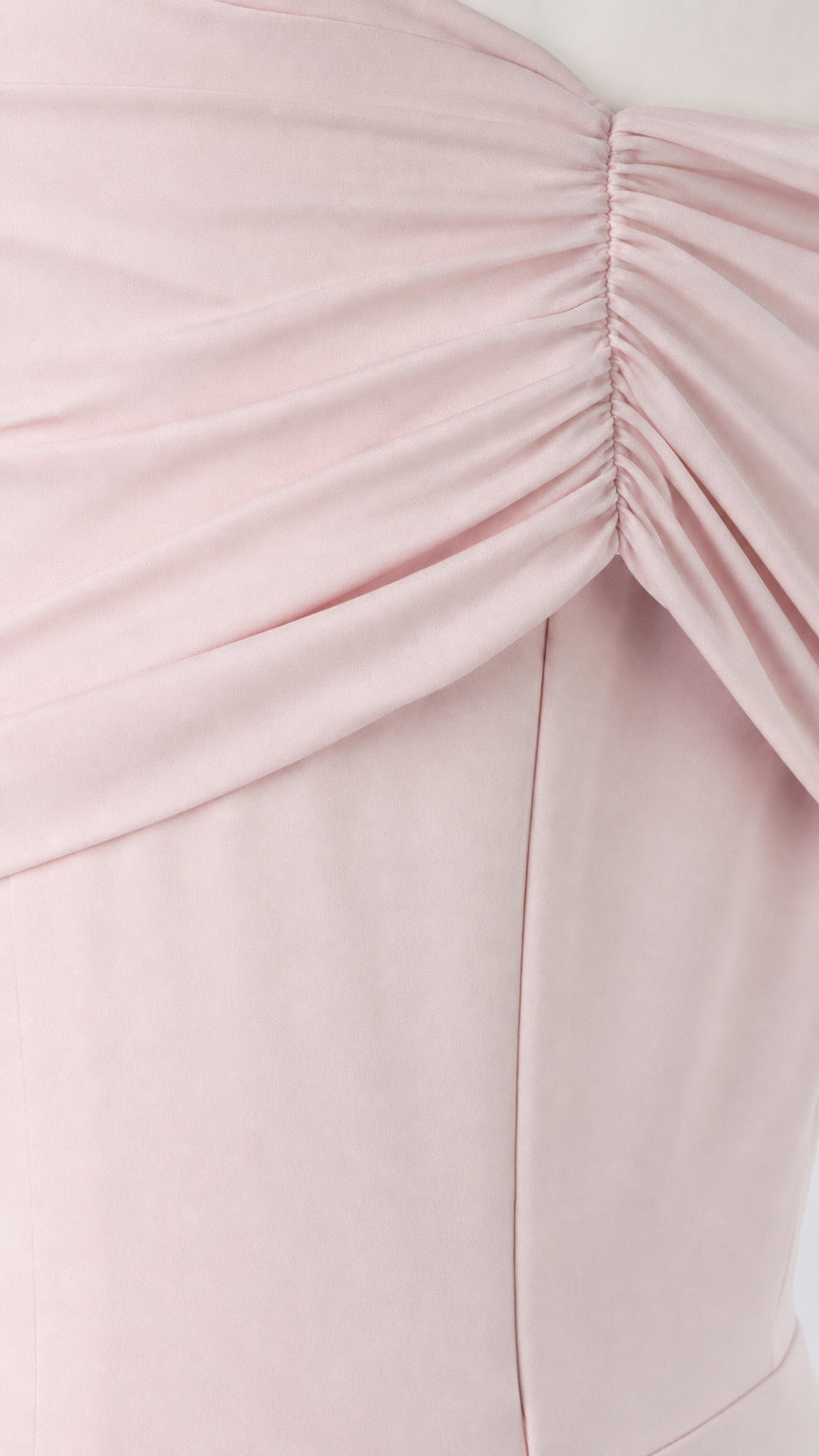 Close-up detail of side waist ruching and draped fabric on formal gown