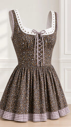 Close-up detail of bodice lacing, eyelet neckline trim, and gingham hem on brown floral dress