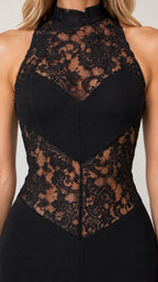 Close-up of intricate floral lace neckline and waist panels on black evening dress