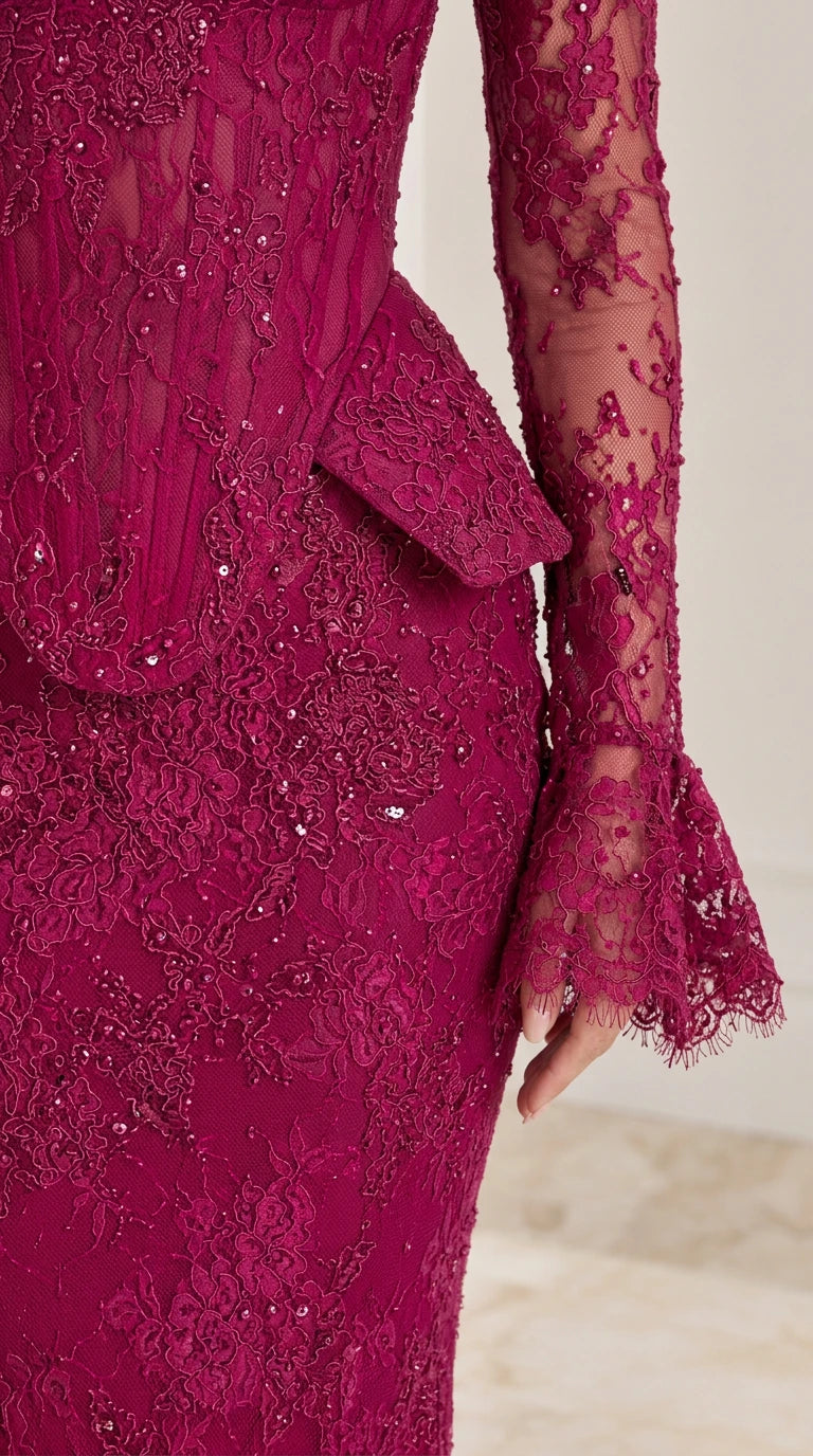 Close-up detail of magenta embroidered lace bodice, peplum waist overlay, and flared bell cuff