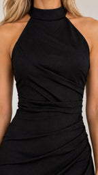 Close-up detail of black ruched bodice and high halter neckline