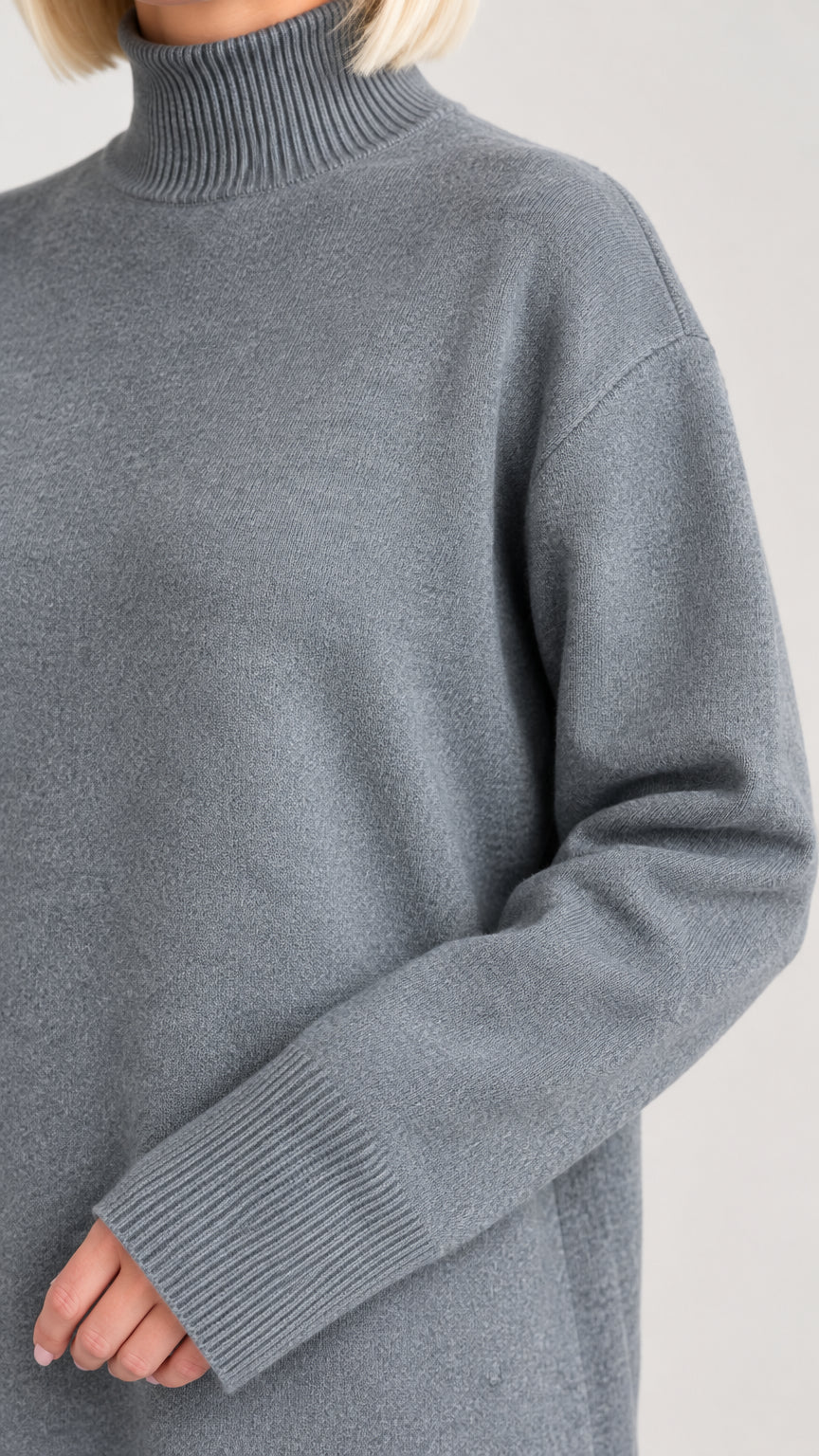 Close-up detail of ribbed mock neck and drop shoulder sleeve texture on slate grey knit dress