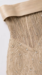 Close-up detail of bodice showing structured boning, intricate beadwork, and satin foldover neckline