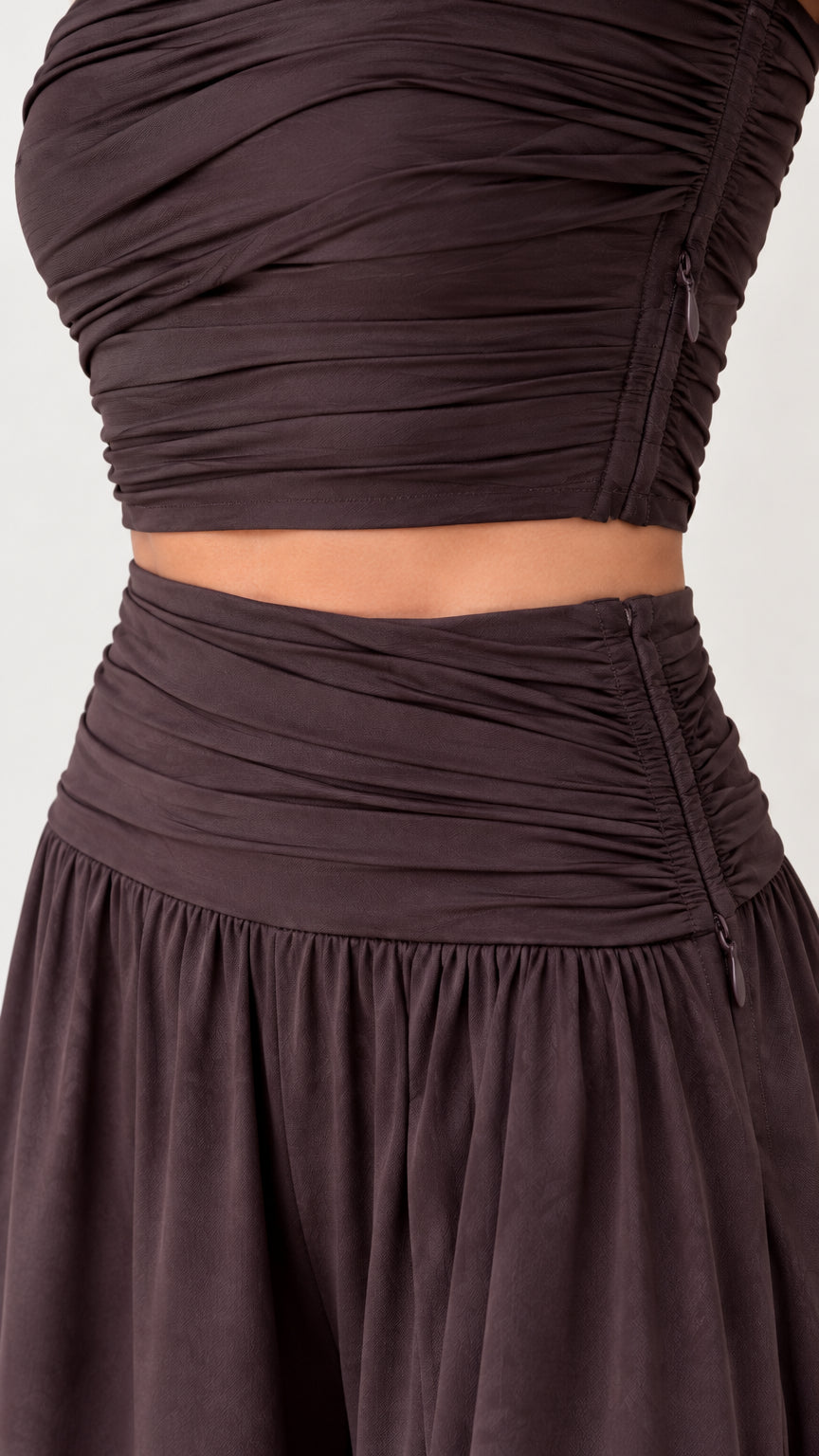 Close-up detail of ruching and side zipper closure on top and trousers