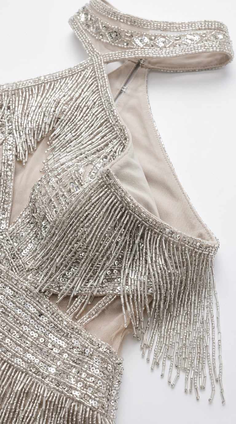 Close-up detail of embellished choker neckline, bust keyhole, and intricate beaded fringe tiers
