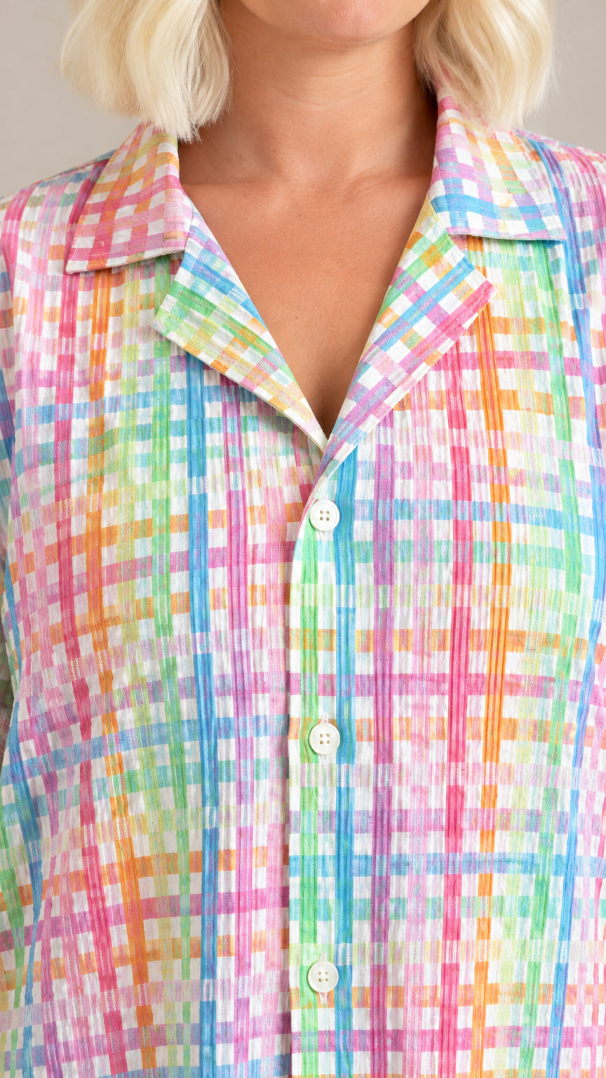 Close-up detail of the camp collar, buttons, and textured plissé plaid fabric