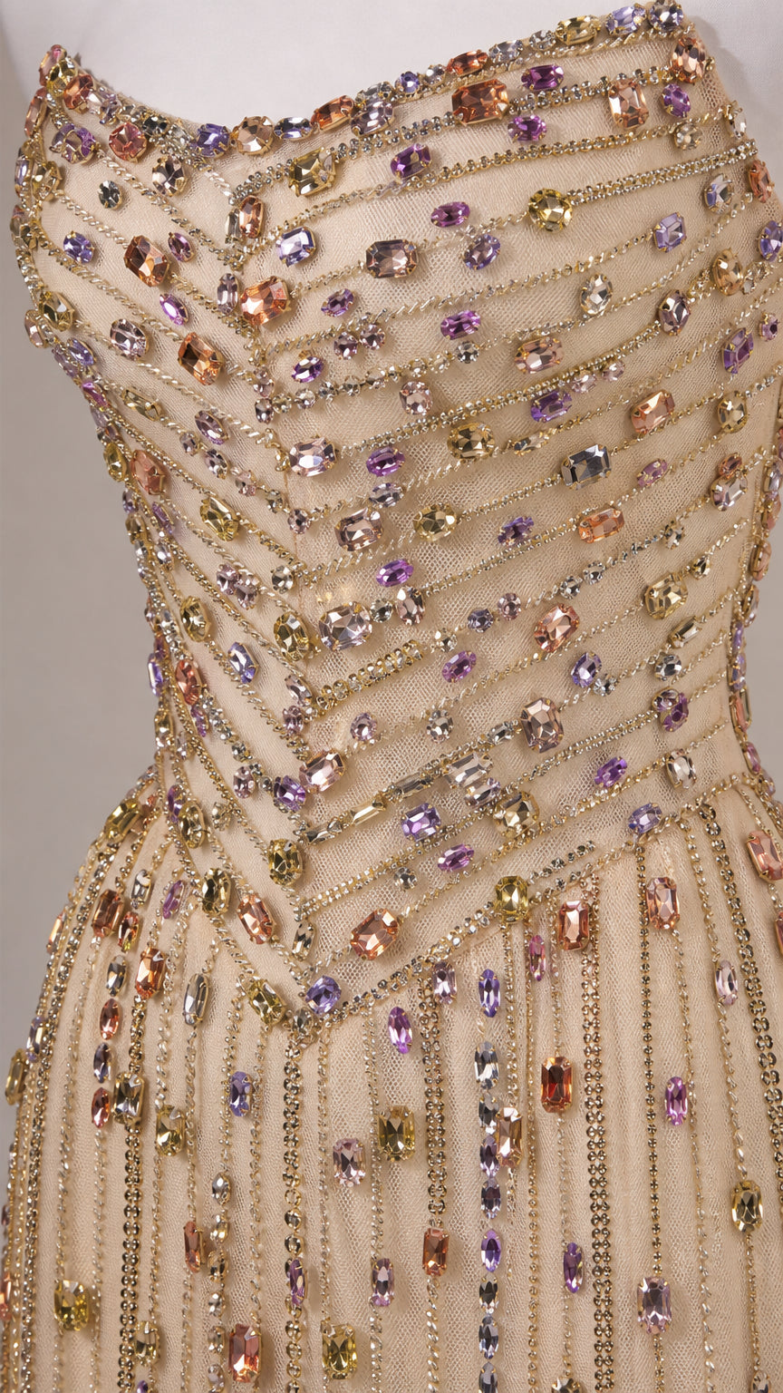Close-up detail of multicolored crystal and bead embroidery on corset bodice