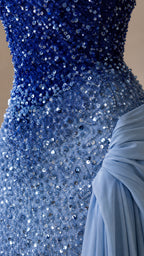 Close-up of blue sequin embellishment and gathered pale blue draped fabric