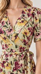Close-up detail of crossover V-neckline and waist tie on floral wrap dress