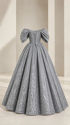 Mannequin display of silver gray off-shoulder sequin evening dress from the back