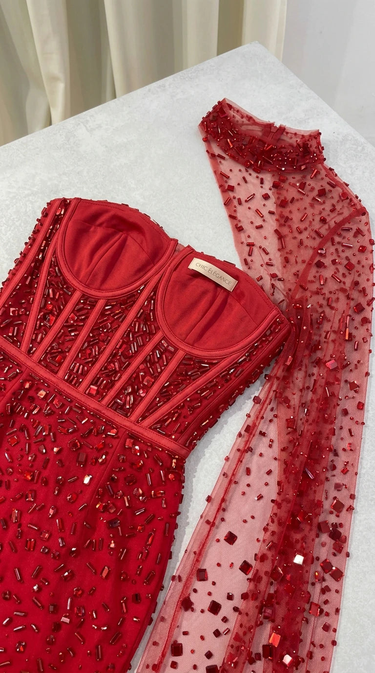 Close-up flat lay of red corset bodice with structured boning and bead embellishments