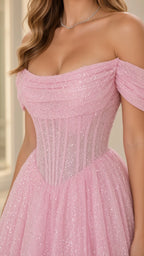 Close-up detail of the pink boned corset bodice and draped off-the-shoulder glitter neckline