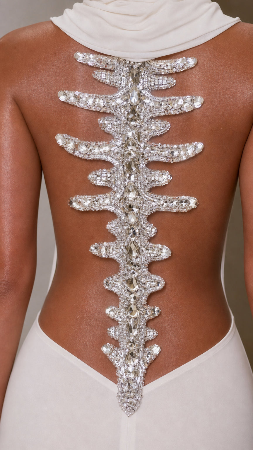 Close-up detail of rhinestone and crystal spine embellishment on open back gown