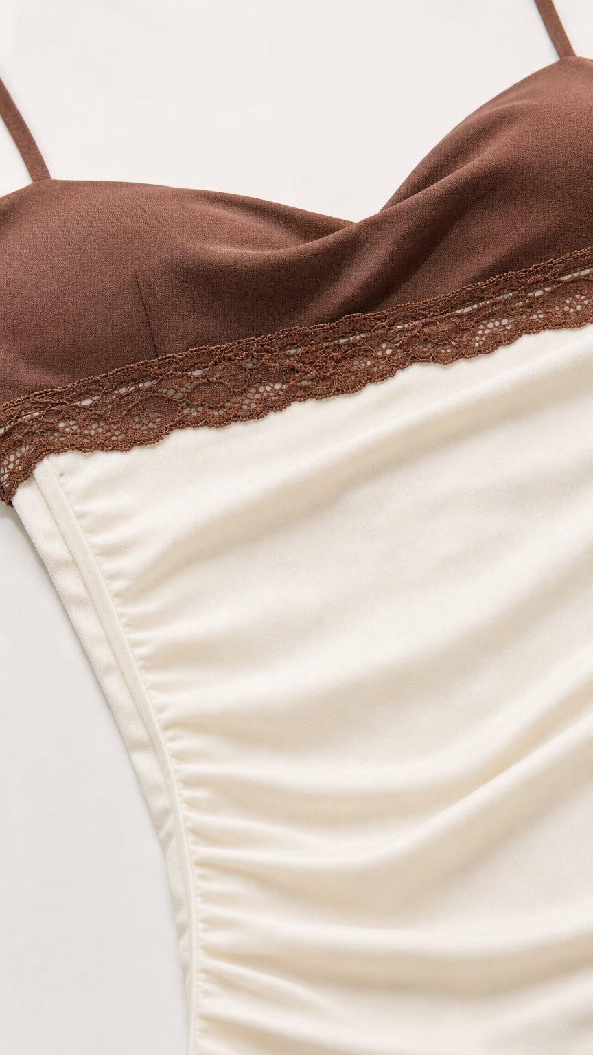 Close-up detail of contrast brown lace trim and soft ruched cream fabric