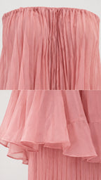 Close-up detail of pleated sheer fabric and flounce hemline on dusty pink gown