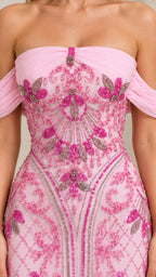 Close-up detail of ornate pink and purple beading on bodice of formal gown