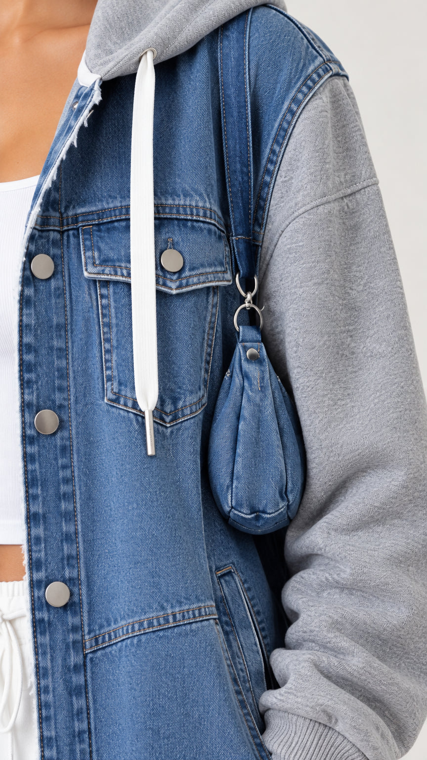 Close-up detail of blue denim texture, chest pocket, button placket, and matching mini accessory pouch