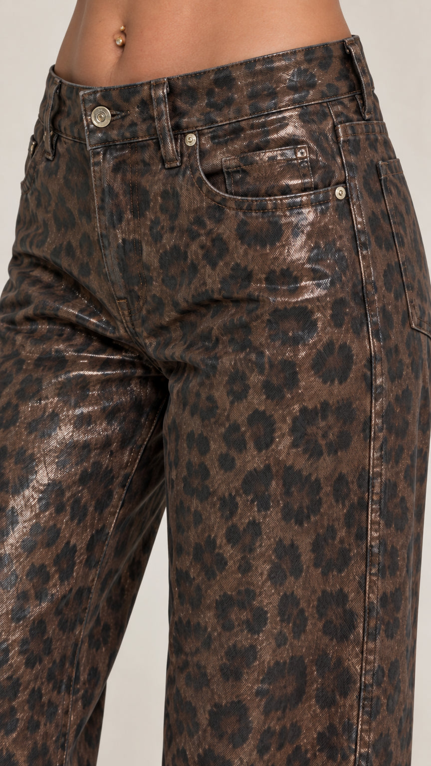 Close-up detail of high waist button fly and metallic leopard print pocket construction