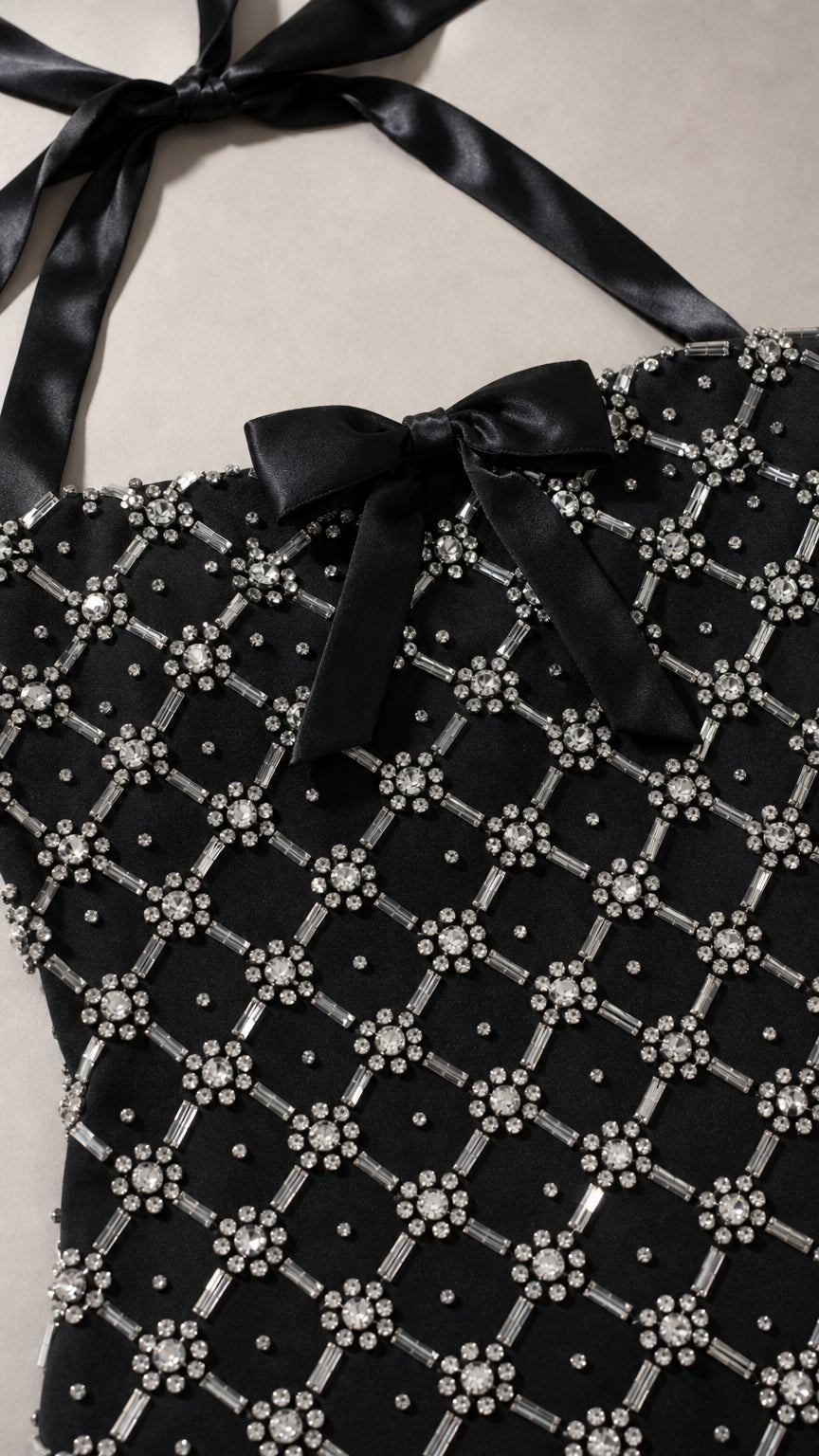 Close-up detail of lattice beading, rhinestones, and satin bow accent