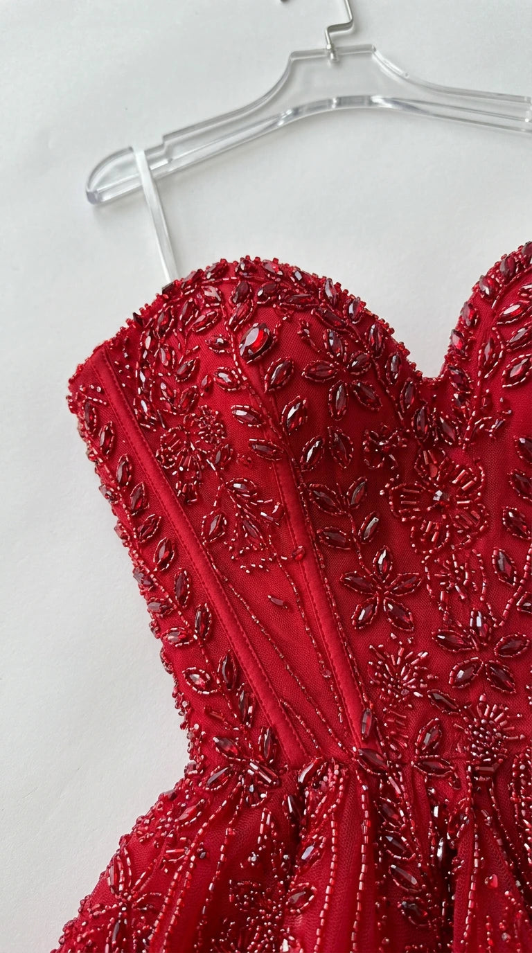 Close-up detail of red floral beading and structured corset boning