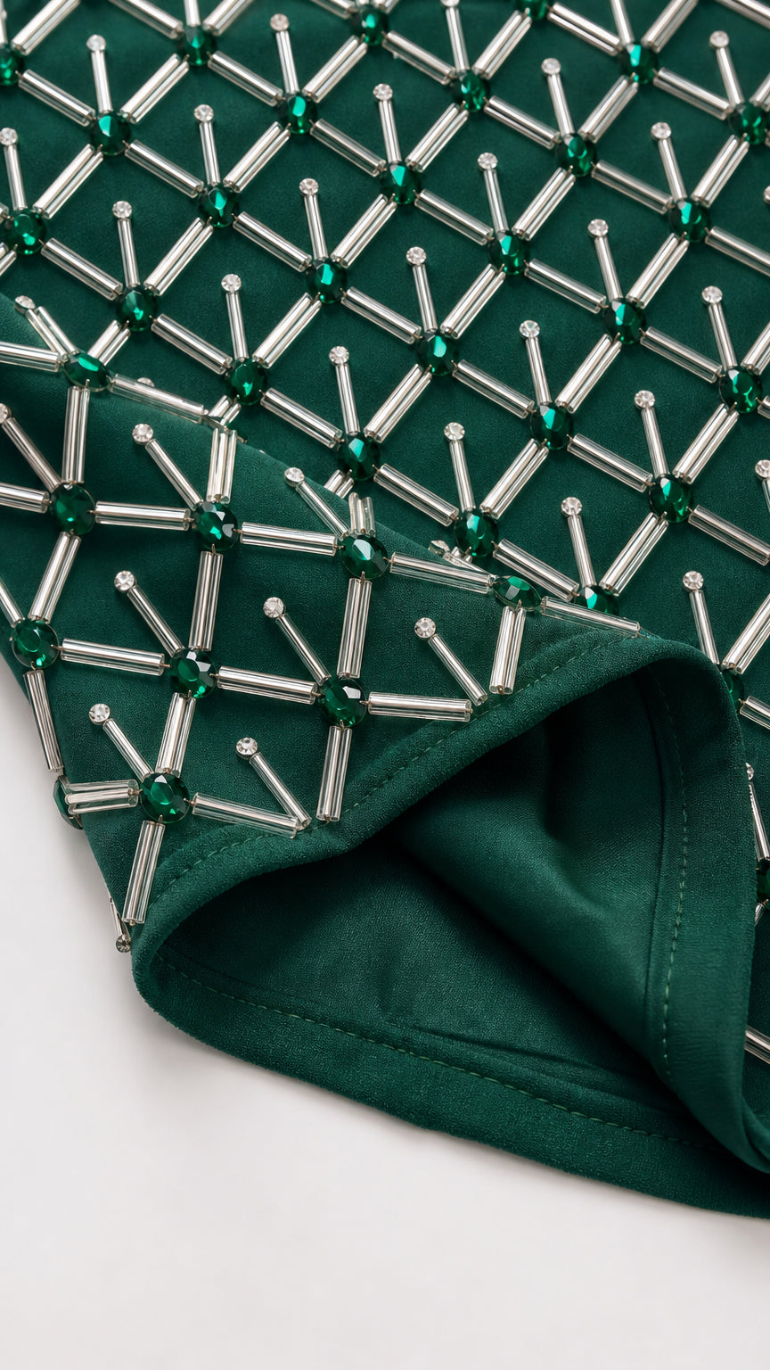 Close-up detail of geometric tube beads and lining on Emerald Green gown