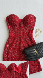 Flat lay close-up of red sequin gown bodice detailing corset boning lines and sweetheart neckline