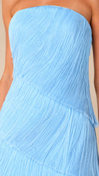 Close-up detail of textured diagonal fringe tiers and strapless neckline on sky blue gown